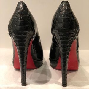Black patent leather high heels with red soles